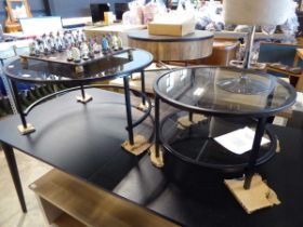 Modern nesting pair of black metal framed circular 'Sofia' coffee tables with glass surfaces