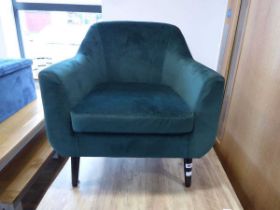 Modern green suede upholstered easy chair on black tapered supports