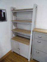 Modern grey slanting shelving unit with cupboard storage to base