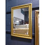 Gilt framed and beveled rectangular wall mirror