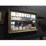 Rectangular gilt framed and beveled wall mirror