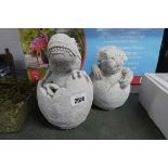 Pair of concrete hatching dinosaurs