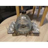 Glass barrel shaped whiskey decanter with 6 glasses on plastic stand