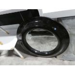 Large circular wall mirror with oversized black frame