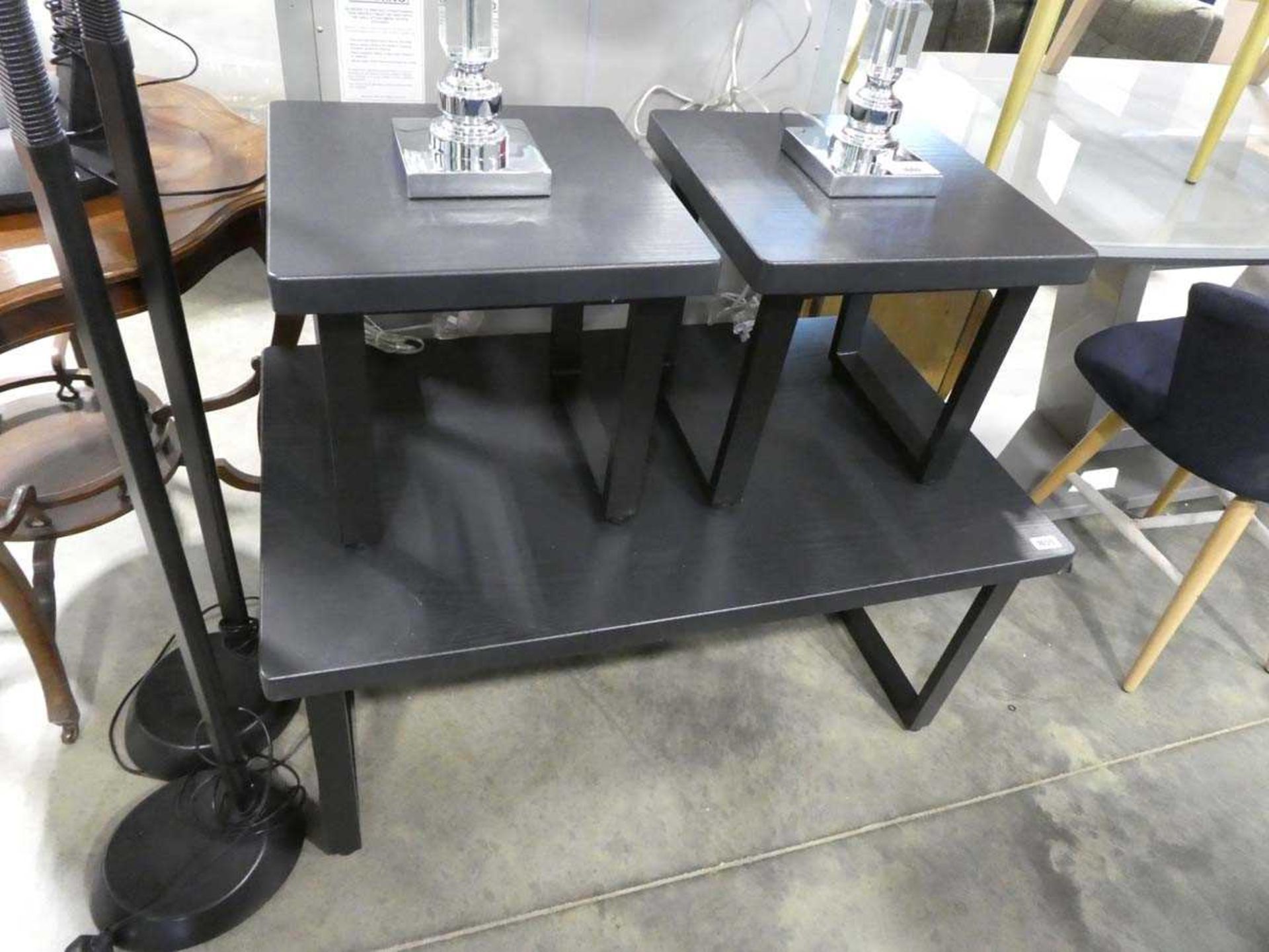 Black ash coffee table on black metal U-shaped supports together with few matching lamp tables