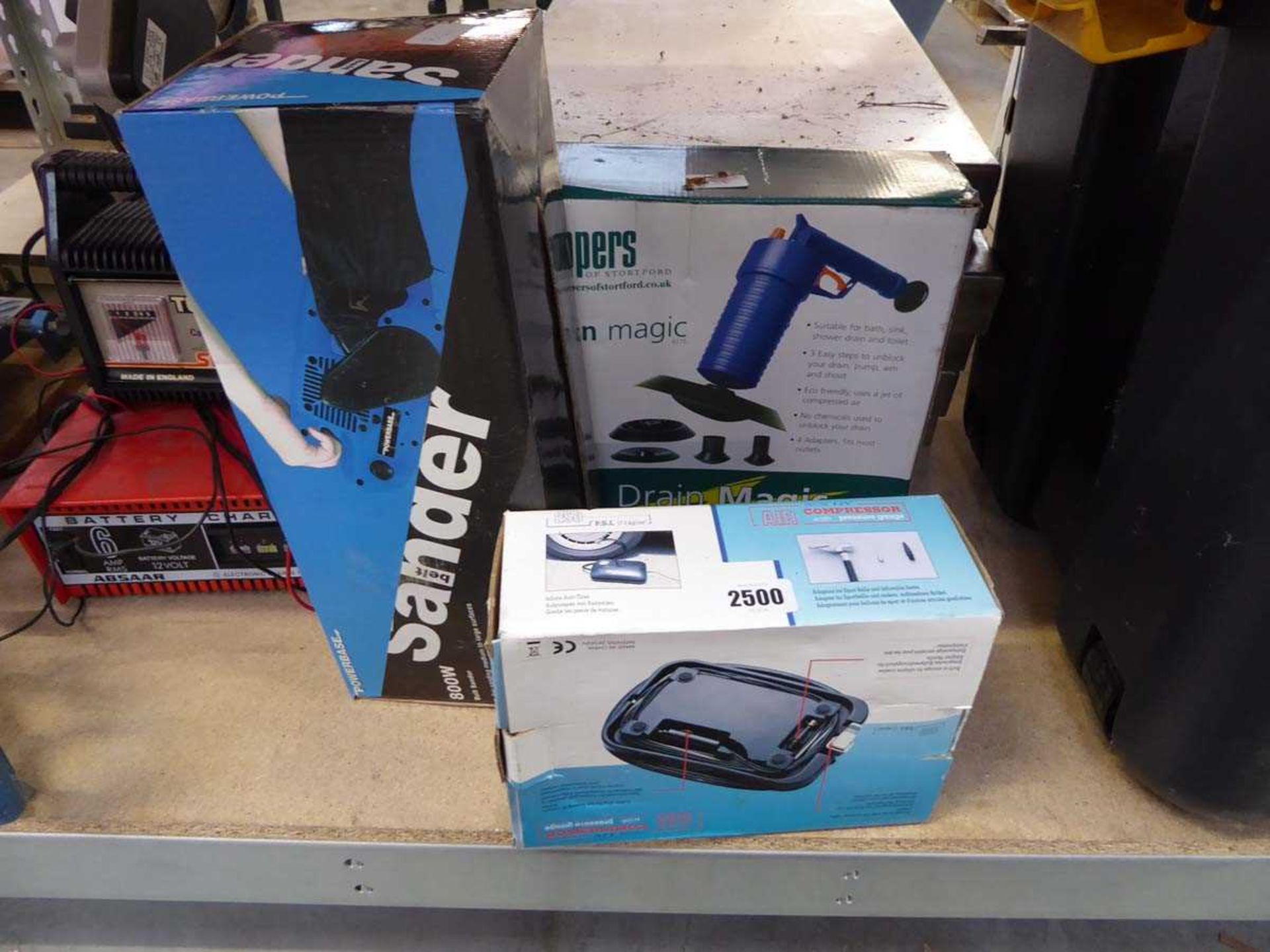 Air compressor, boxed belt sander and boxed Drain Magic system