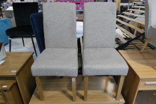 2 grey upholstered dining chairs on oak effect supports
