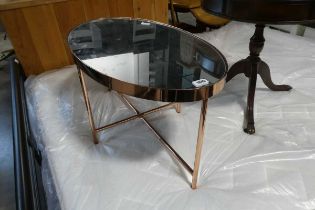Copper coloured oval table with mirrored surface