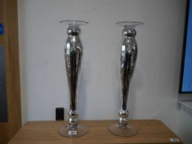 Modern pair of glass and silver coloured candlesticks