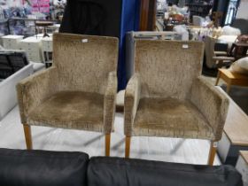 Modern pair of giraffe patterned carver dining chairs on light oak supports