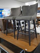 Pair of grey suede diamond stitch upholstered bar stools on black tapered supports