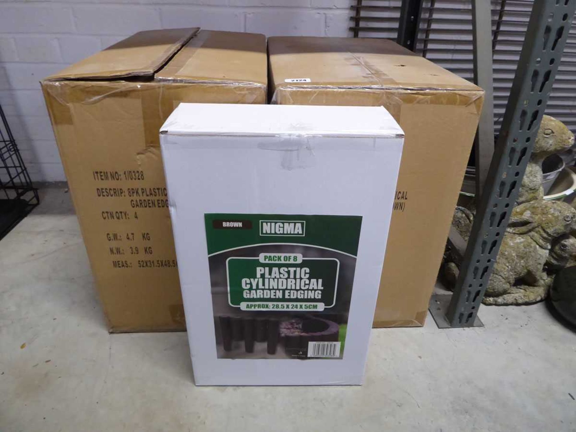 2 boxes containing 8 packs of dark brown plastic cylindrical garden edging