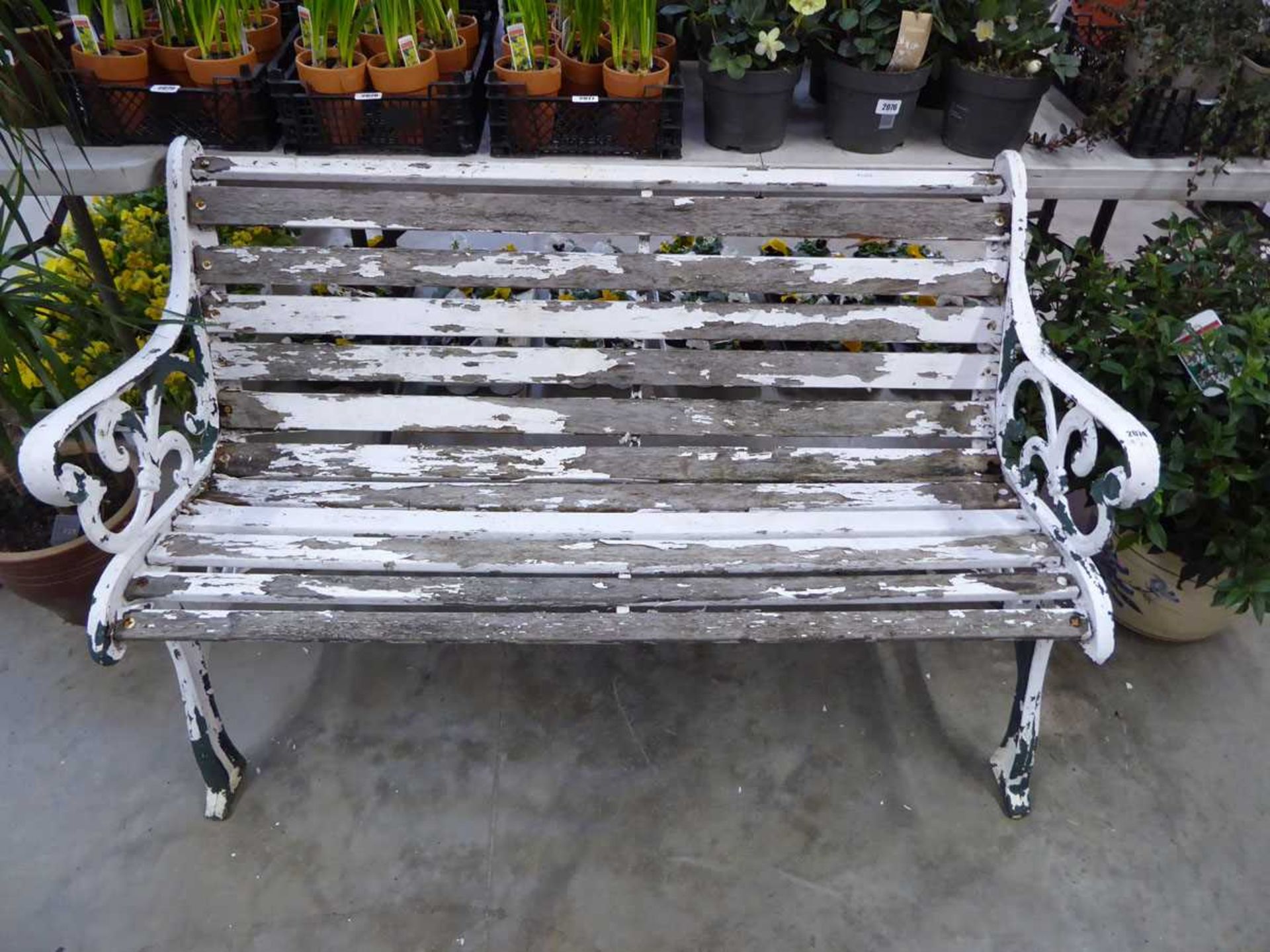 Weather wooden slatted metal ended garden bench