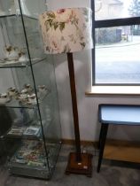 Dark oak standard lamp base with a cylindrical floral shade