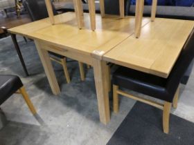 Modern light oak drawer leaf dining table with 6 matching modern dining chairs, including 4 black