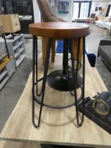 Circular pine finish stool on black wirework supprt