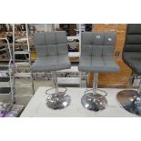 Pair of grey leatherette and chrome height adjustable bar stools