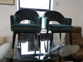 Modern pair of 2 green velvet upholstered bucket seated dining chairs on black tapered supports