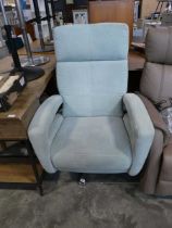 Light teal upholstered easy chair on 5 star chrome swivel base
