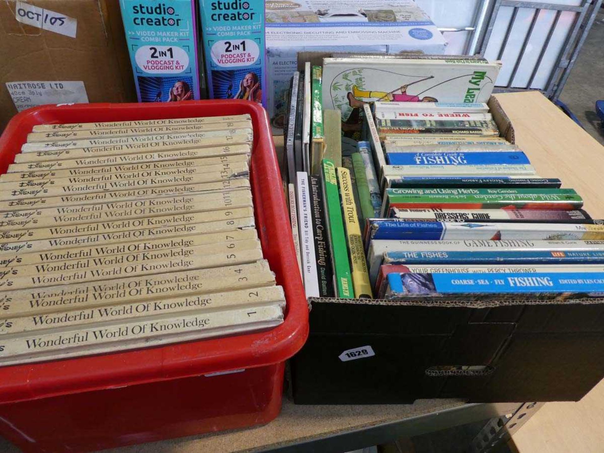 Plastic crate containing Disney's Wonderful World of Knowledge books and another tray of fishing