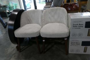 Modern pair of beige corduroy upholstered easy chairs on tapered supports