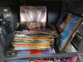 Cage containing albums including Genesis, Rod Stewart and Bob Dylan
