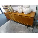 Mid century teak sideboard with 3 off-centre drawers and 3 cupboards