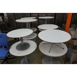 12 mixed size white circular topped commercial tables on metal legs