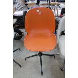 Orange plastic swivel office armchair on chrome 4 star base