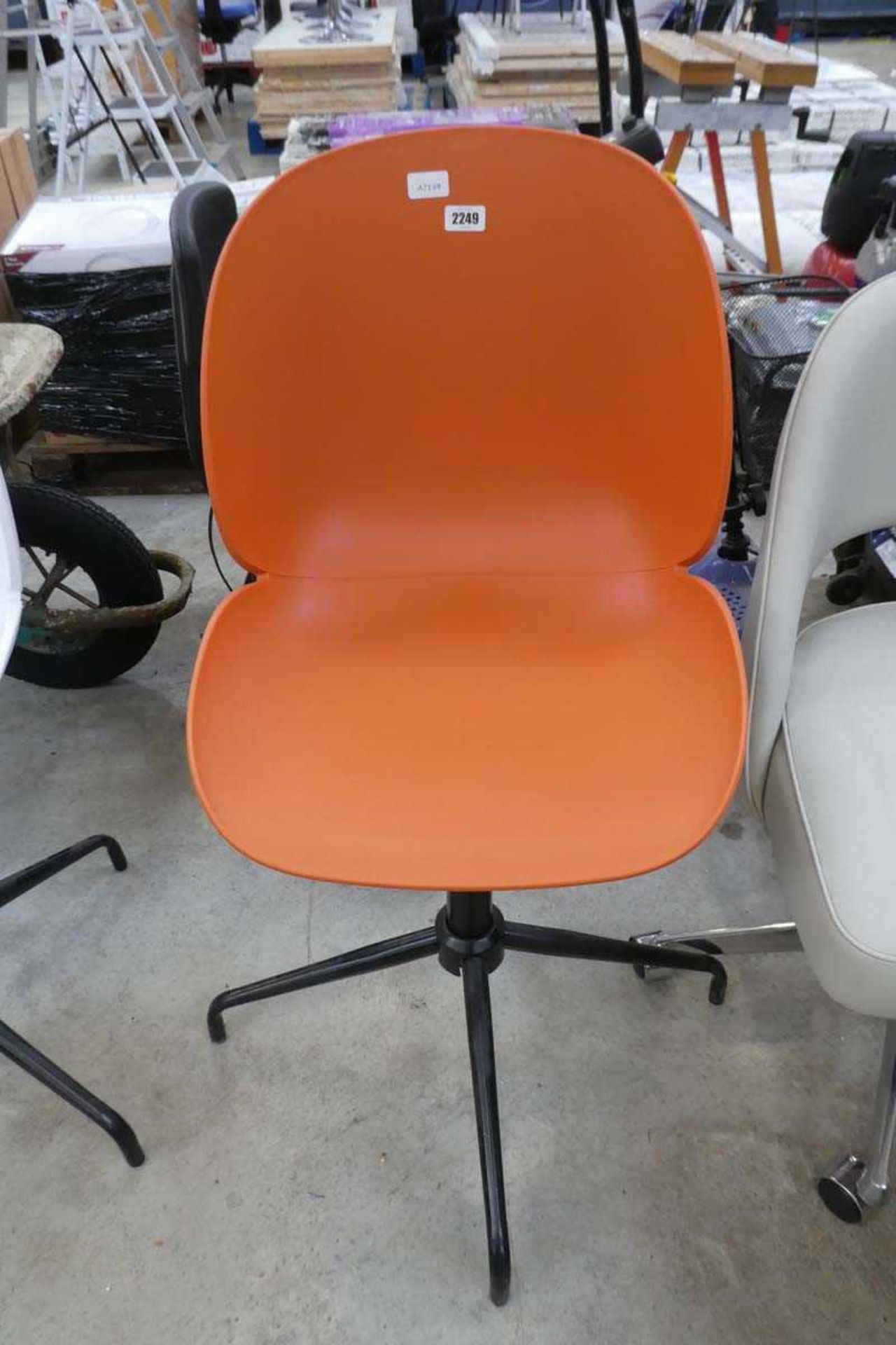 Orange plastic swivel office armchair on chrome 4 star base