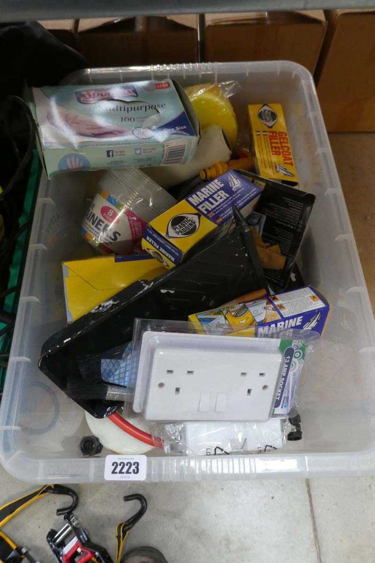 Crate of mixed items to include 13amp sockets, paint brushes, multipurpose disposable gloves etc.