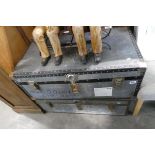 2 twin handled grey packing trunks