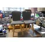 Modern pair of grey upholstered dining chairs on white oak supports