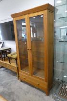 Modern light oak display cabinet with lower drawer