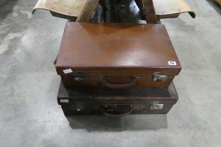 2 brown leather suitcases