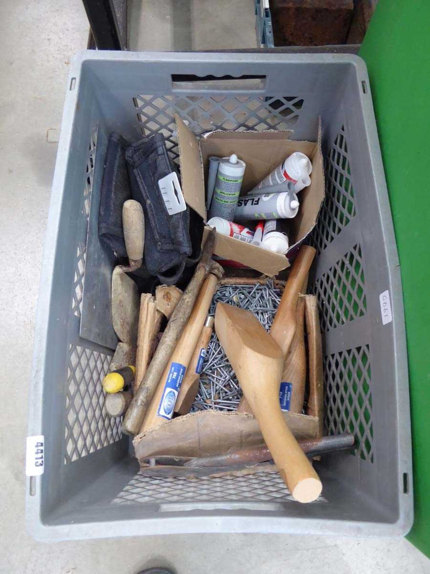 Large plastic crate containing nails, leadbeaters, trowels, silicon etc.