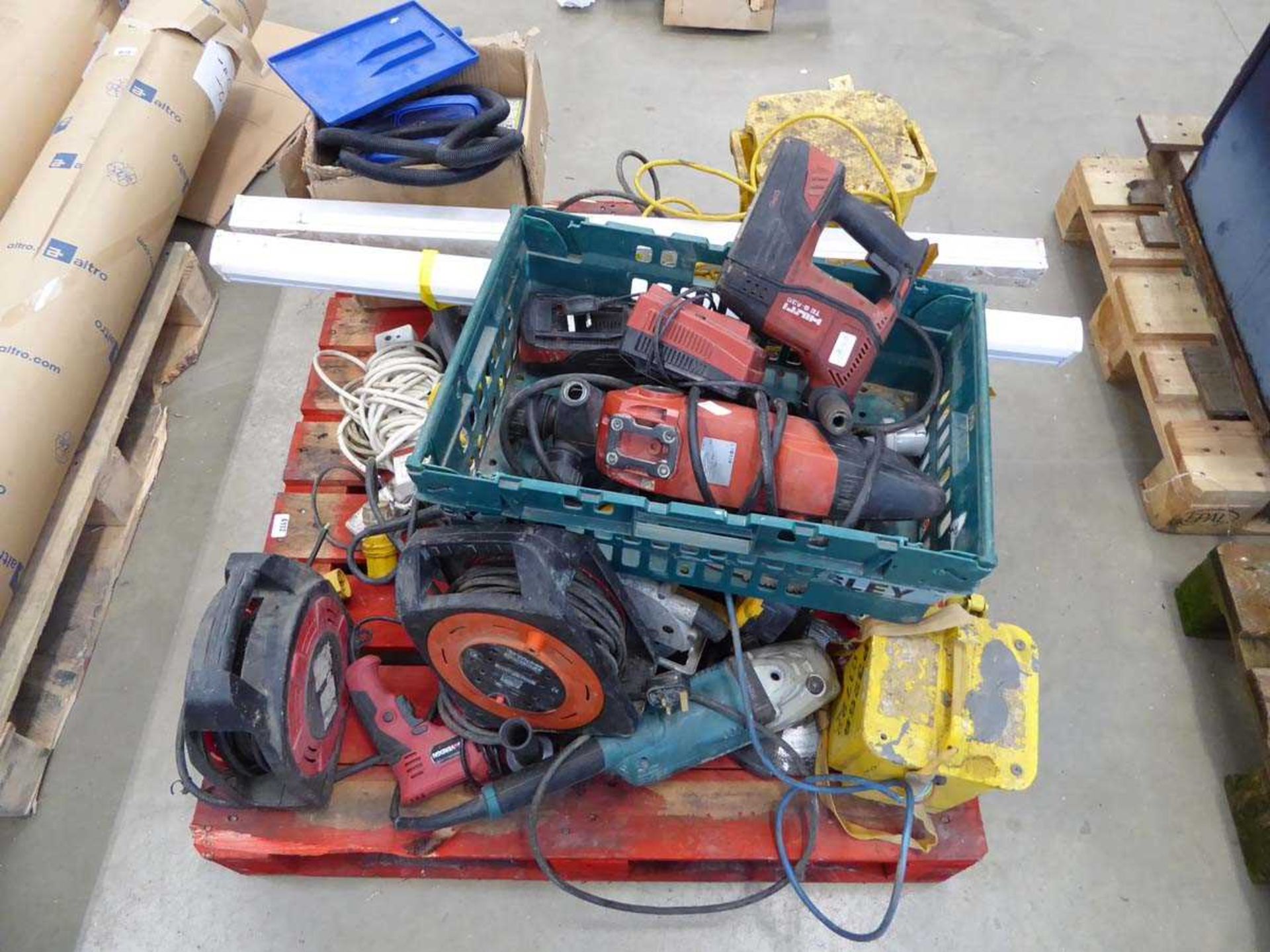 Pallet of assorted items including Hilti drills, angle grinders, transformers, leads, circular