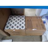 12 boxes of black and cream patterned tiles