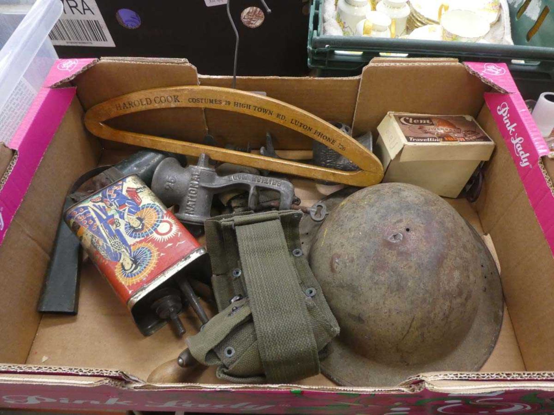 Box containing meat mincers plus military webbing and a helmet