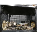 Cage containing loose silver-plated cutlery, goblets, coasters and collectors plates