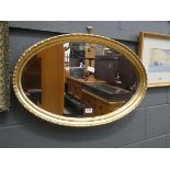 Oval bevelled mirror in gilt frame