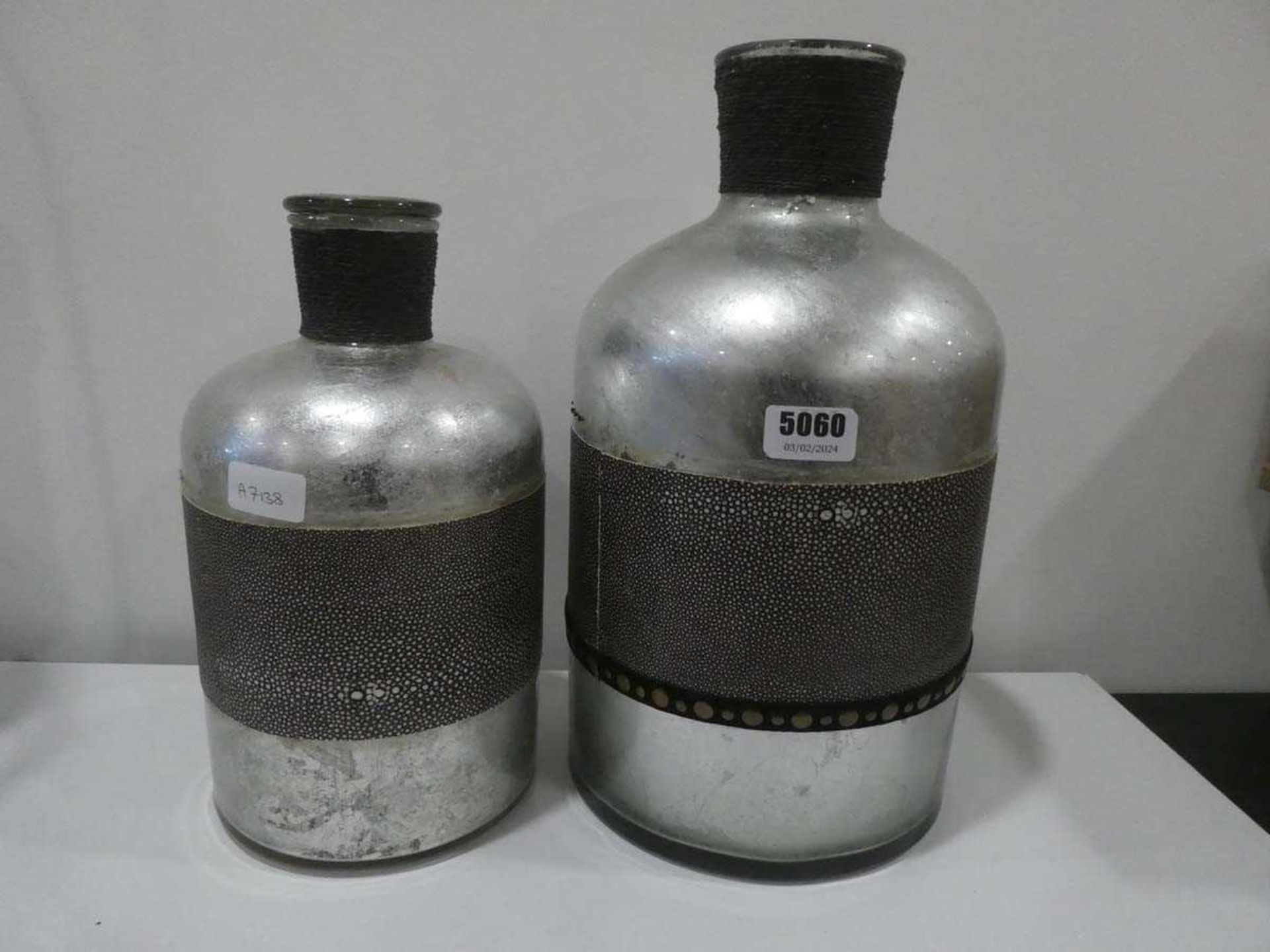Two painted glass bottles with single stopper