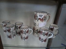 Patterned pottery wine jug and six cups