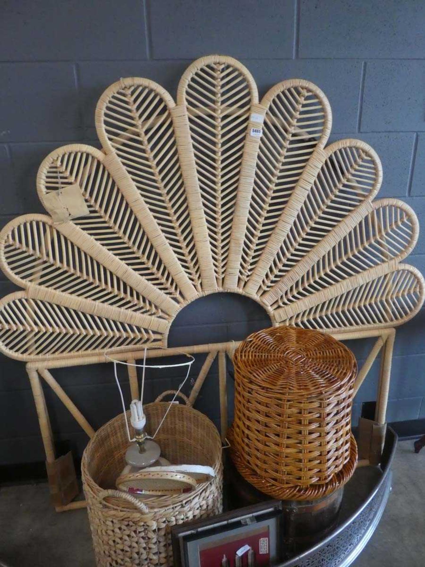 Wicker headboard, quantity of wicker baskets, table lamp, fire curb and two squash racquets