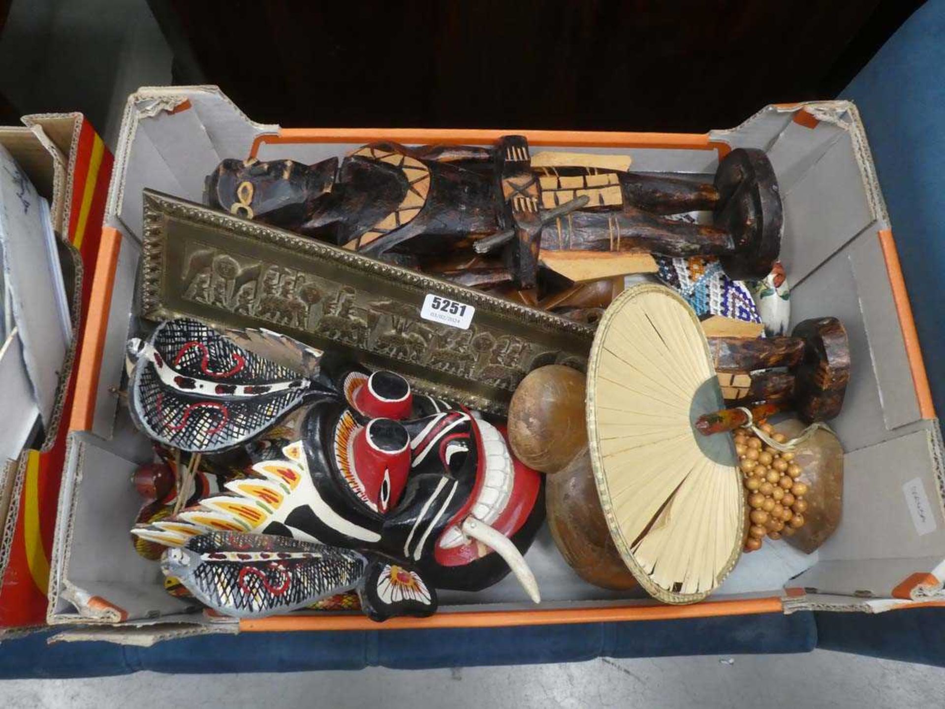 Box containing carved African and other masks, plus a beaded cows horn