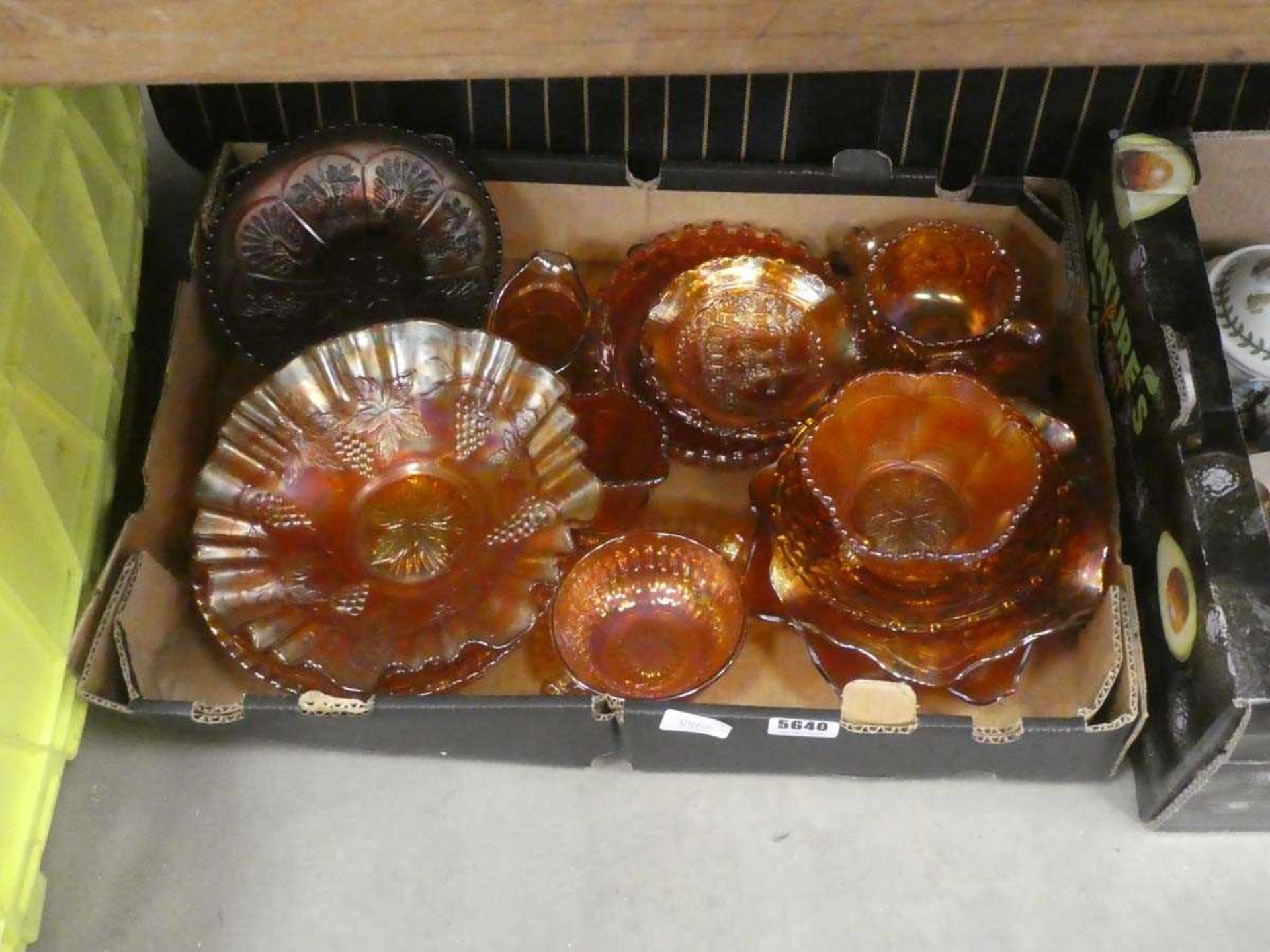 Box containing carnival glass dishes and plates