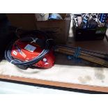 Small Champion electric pressure washer and a set of drain rods