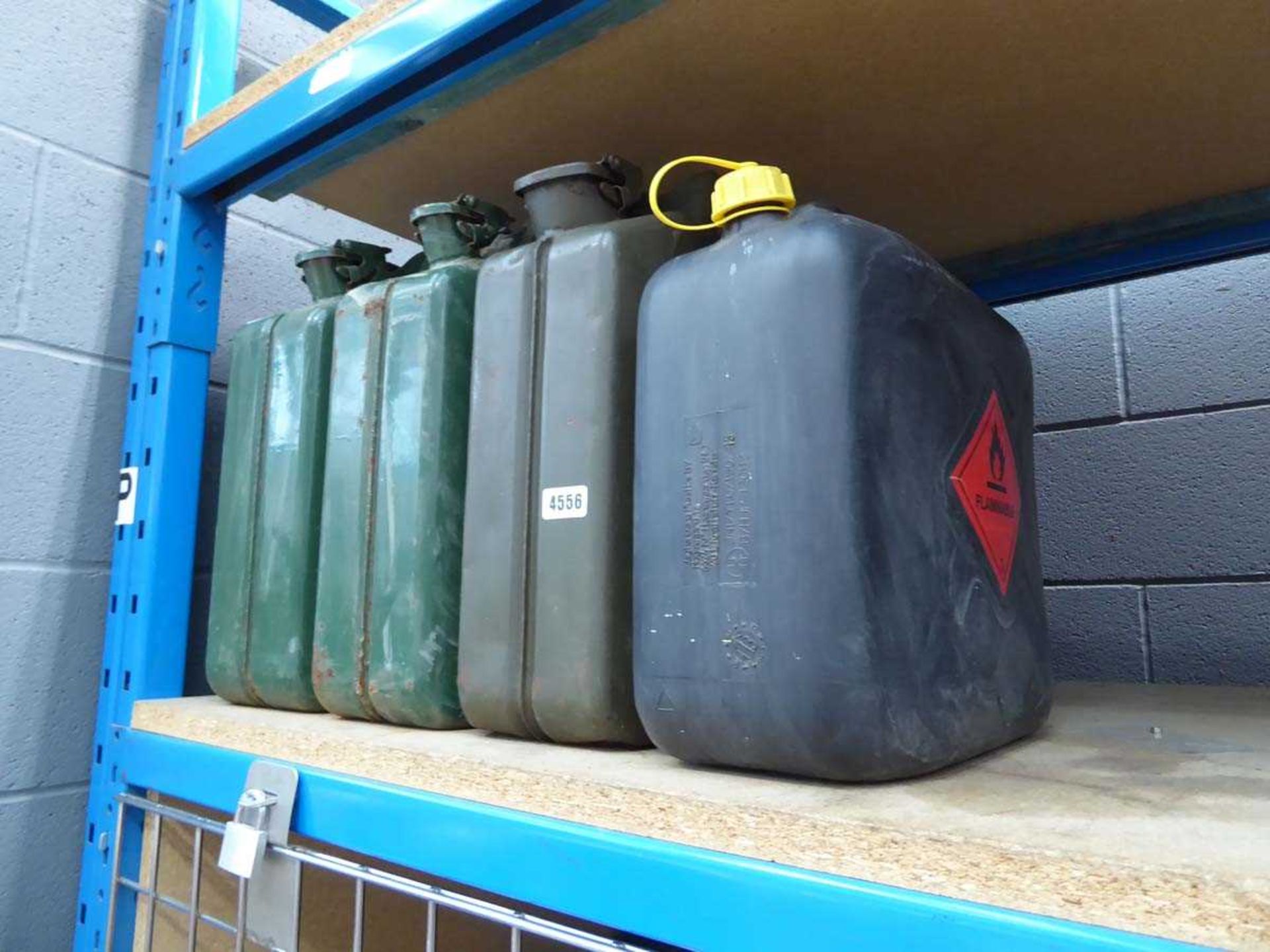 3 metal green jerry cans and a plastic jerry can