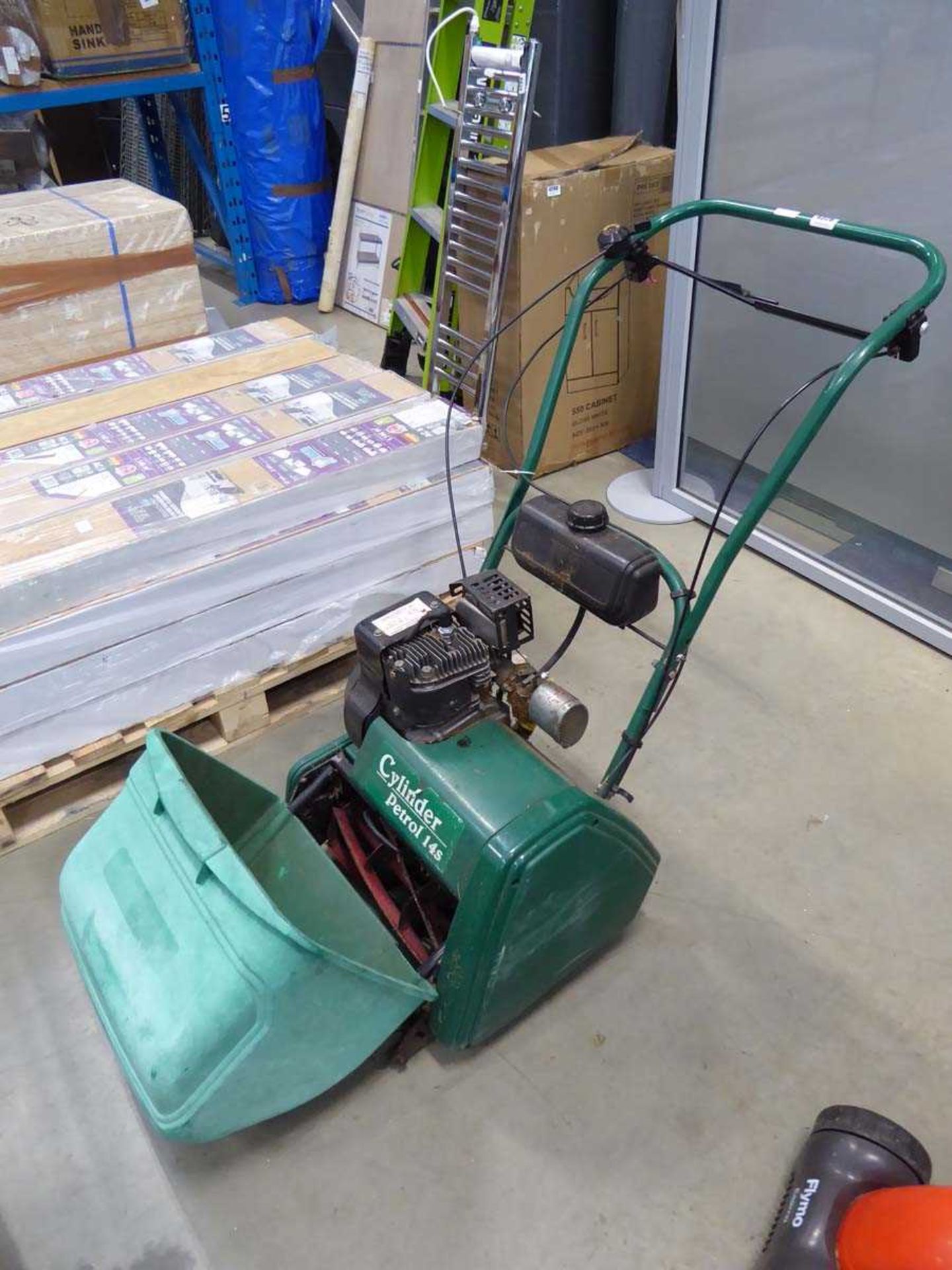 Green petrol powered cylinder mower with grass box