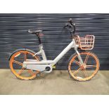 Silver orange bike with front rack